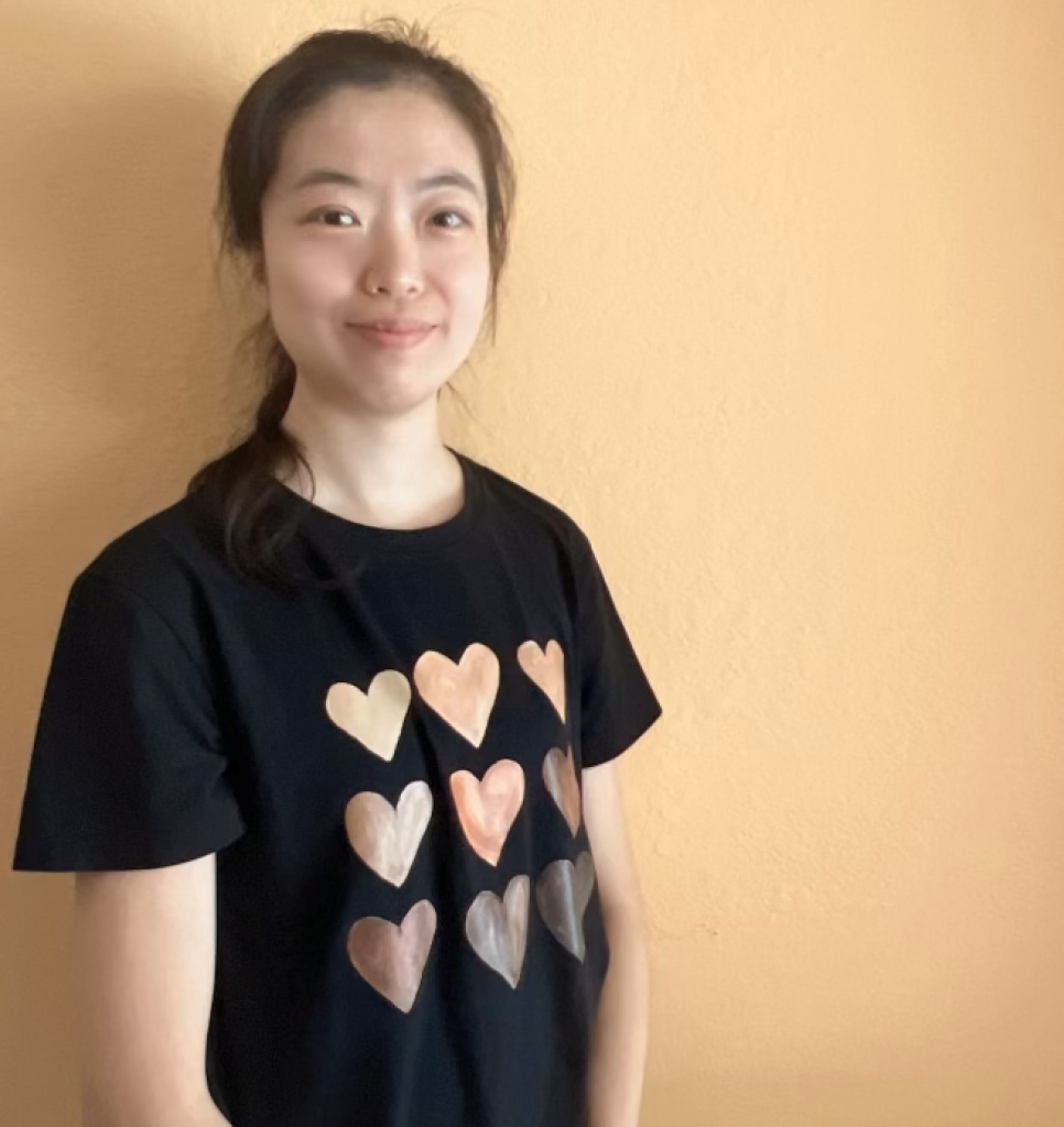 Daisy Ding in black shirt with hearts on it