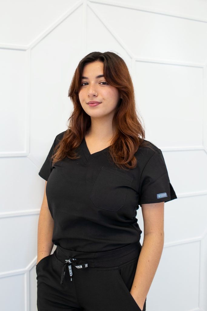 Ava MAzzie in black scrubs at the Garden Medical Spa, Wellness and Massage in North Palm Beach, FL