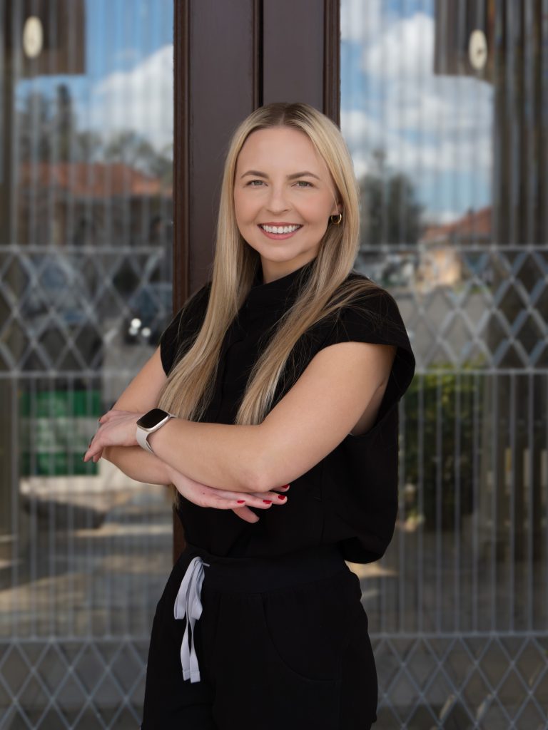 Melanie Rorer, APRN, FNP-C in black scrubs at the Garden Medical Spa, Wellness and Massage